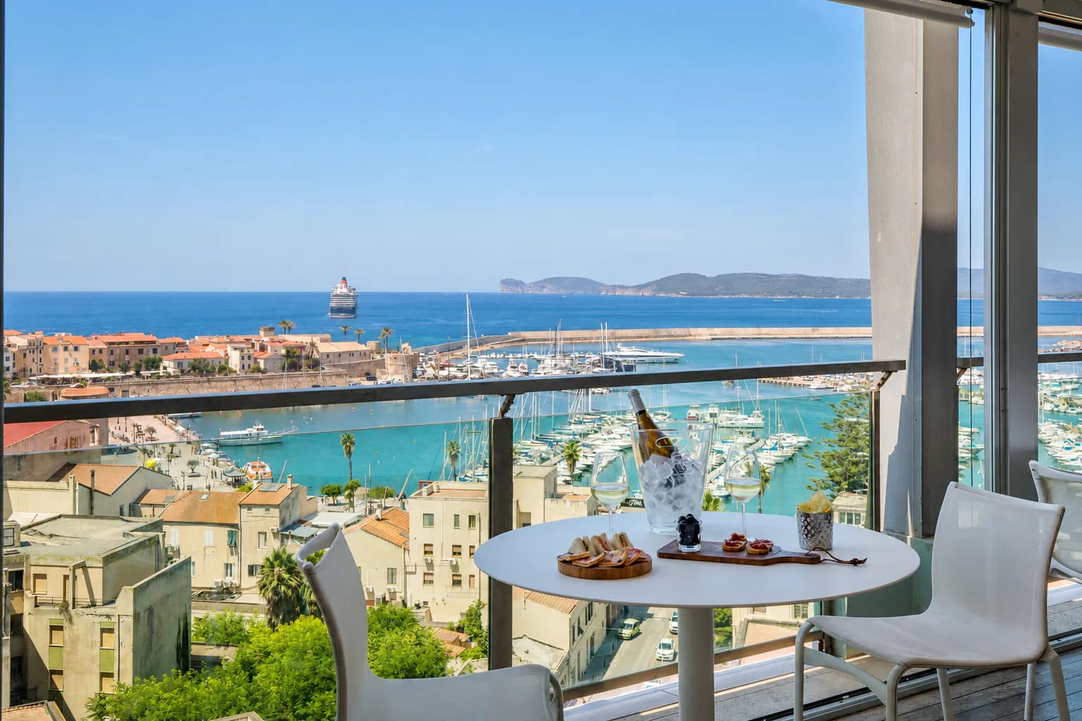A terrace table overlooking Alghero marina and coast